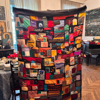 Nino modestly hides behind her creation