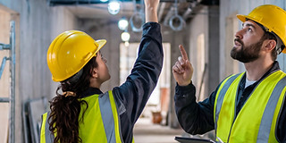 vecteezy_male-and-female-engineers-inspecting-ceiling-electrical_82280172.jpg
