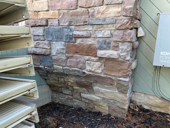 Manufactured stone stained multiple colors