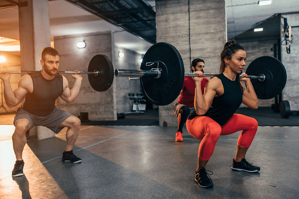 group of people squatting with bar and weights