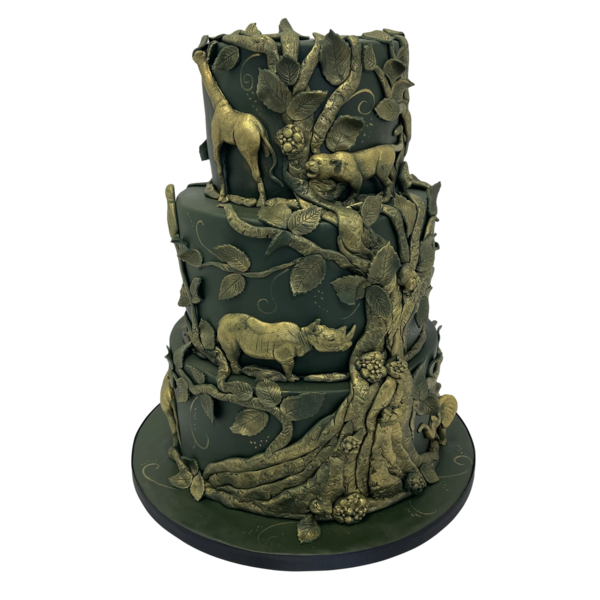 Three-tiered luxury wedding cake with safari theme, featuring animals and foliage in sugar paste.