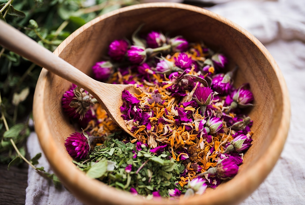 mixing colorful natural dye herb blend with globe amaranth, calendula and mint leaves