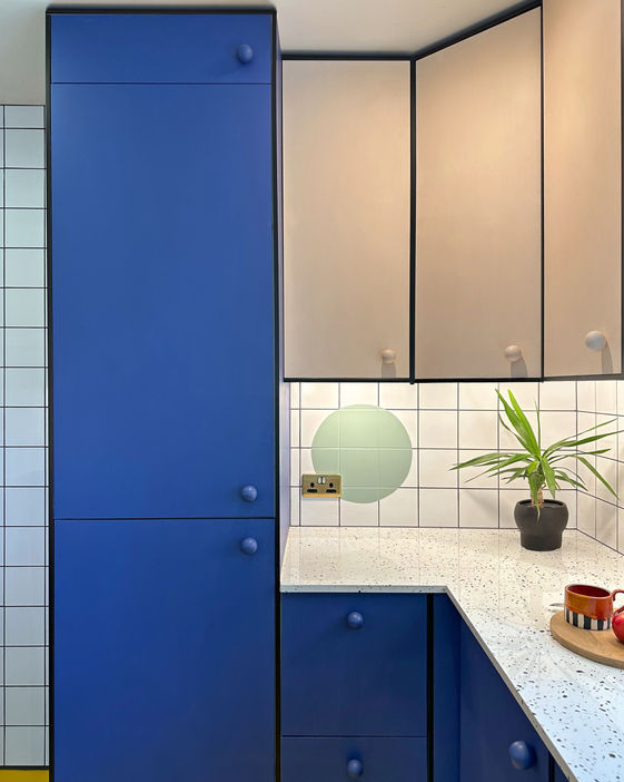 Hannah Drakeford small, colourful memphis design style kitchen, bright yellow floor, painted tiles, geometric shape murals, modified Ikea kitchen units Metod, painted tiles