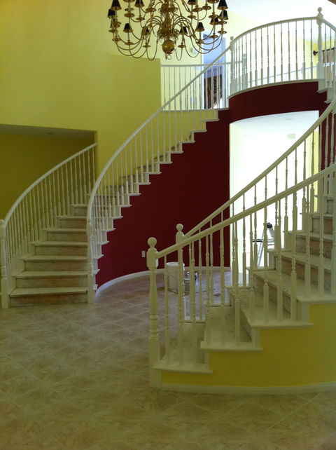 Bold and beautiful yellow and dark red wall colors in a magnificent double stairway.