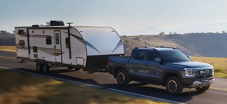 BYD Shark pickup towing a travel trailer