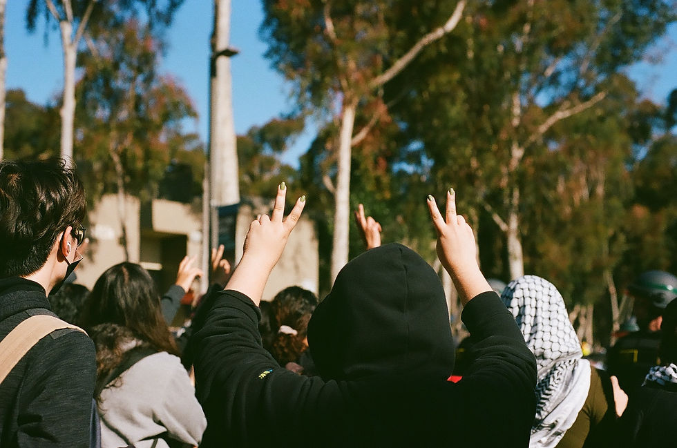 Peace signs held up by protesters toward police.