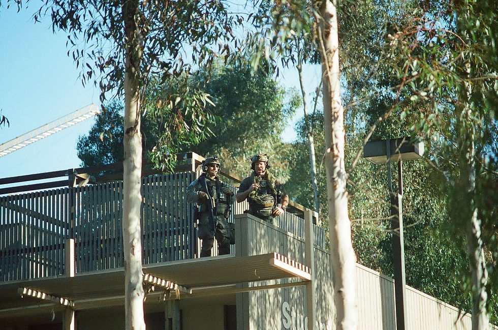 Police jeer at protesters from the roof of the Student Health Services Center.