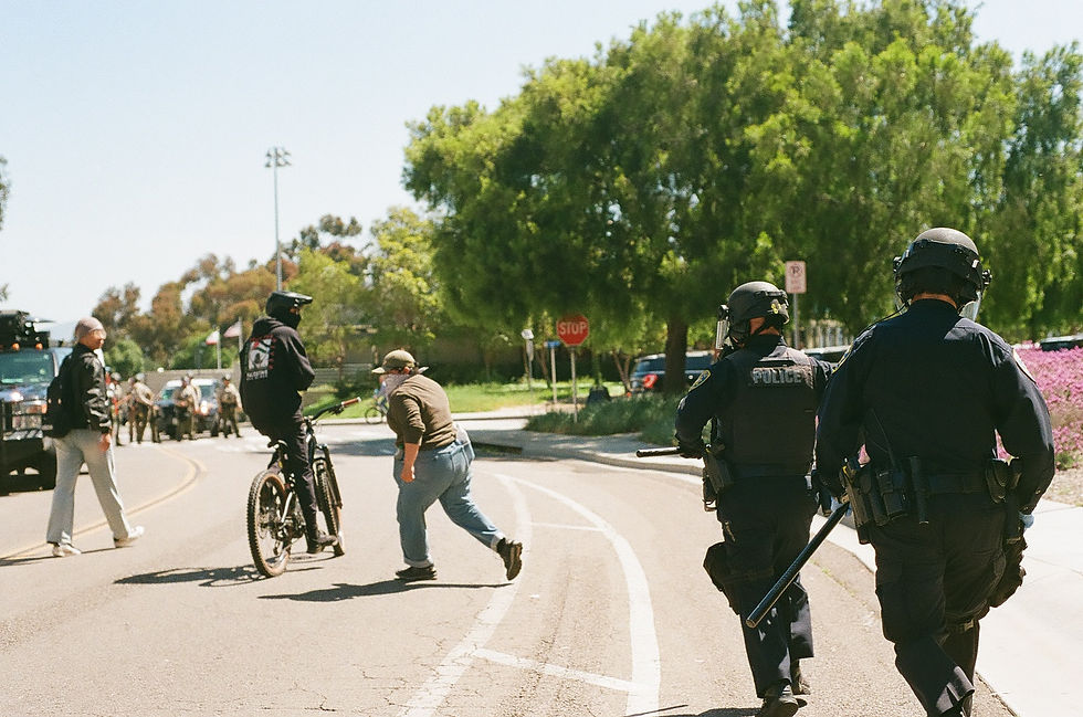 A protestor is chased down by police.