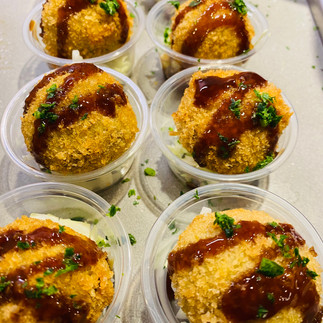 Japanese curry croquettes in small clear plastic single serving containers.