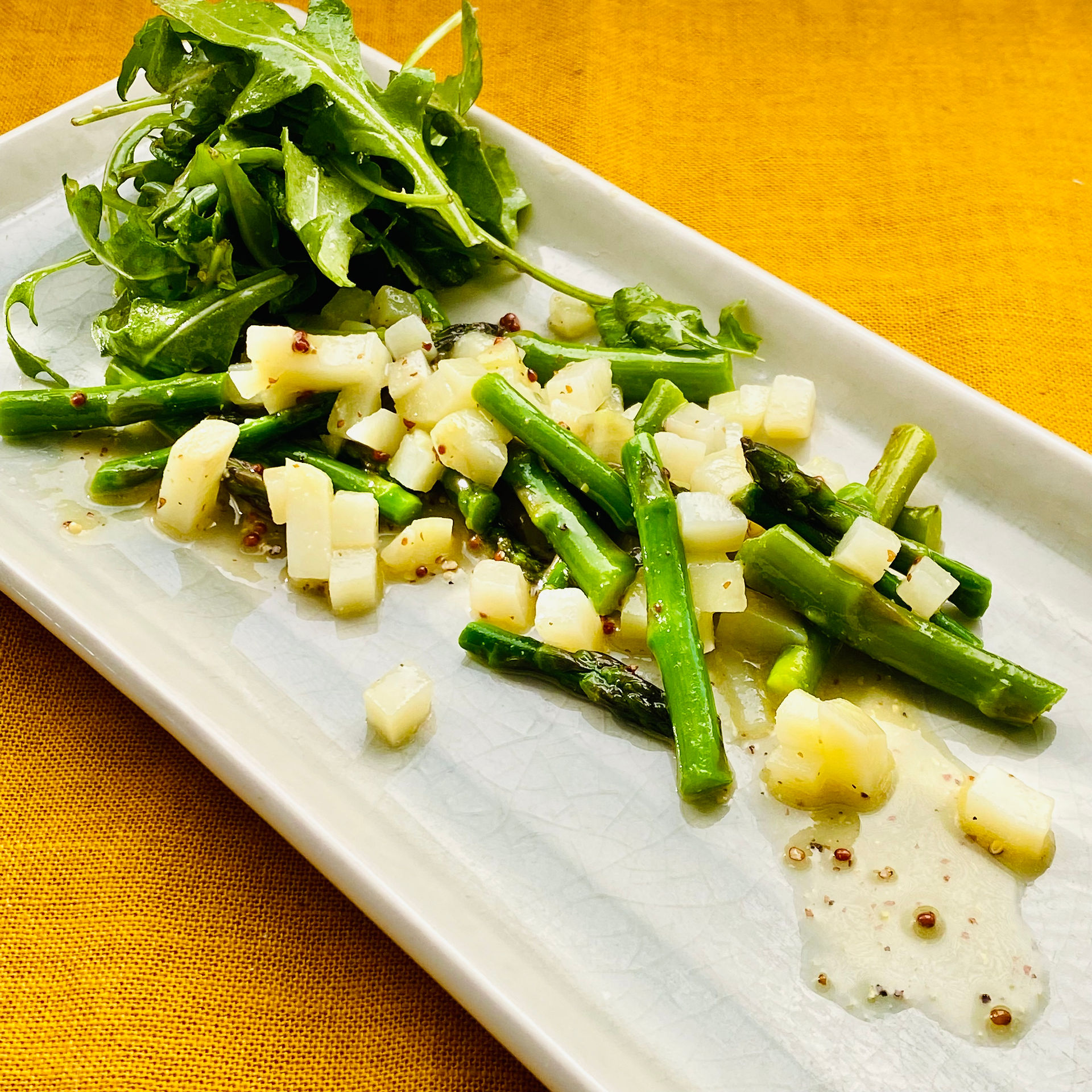 Asparagus and Potato Salad cut up on a long rectangular plate