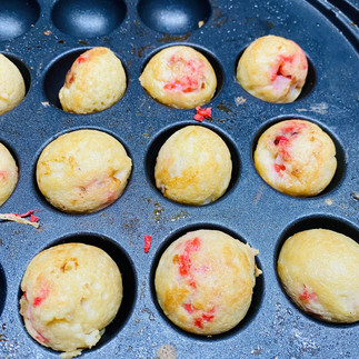 Japanese street food, Tako Yaki (Takoyaki is a ball-shaped Japanese snack made of a wheat flour-based batter filled diced octopus and red ginger in a round shaped molds in a cast iron)  