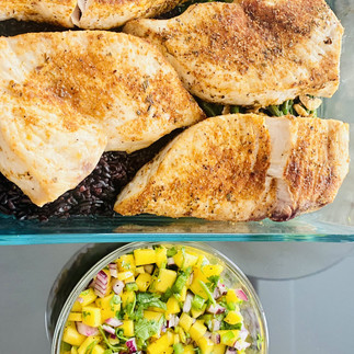 Sword Fish and Mango Salsa. Grilled Sword Fish in a rectangular glass container on top of the photo, bedded with Black rice, Blanched Green Beans and Crispy Garlic. On the bottom of the photo, Mango Salsa with minced Mango, minced red onions, minced jalapeno and cilantro in a small round glass container. 