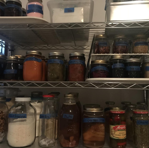 Pressure canned sauces and stock jars on closet shelf