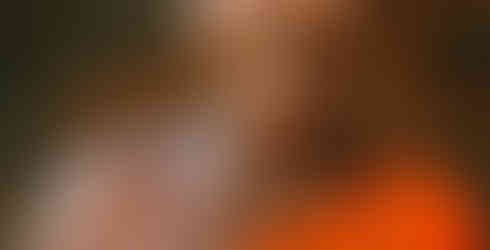 Araku Valley, AP, India:  Woman in Orange Floral Sleeveless Dress Smiling