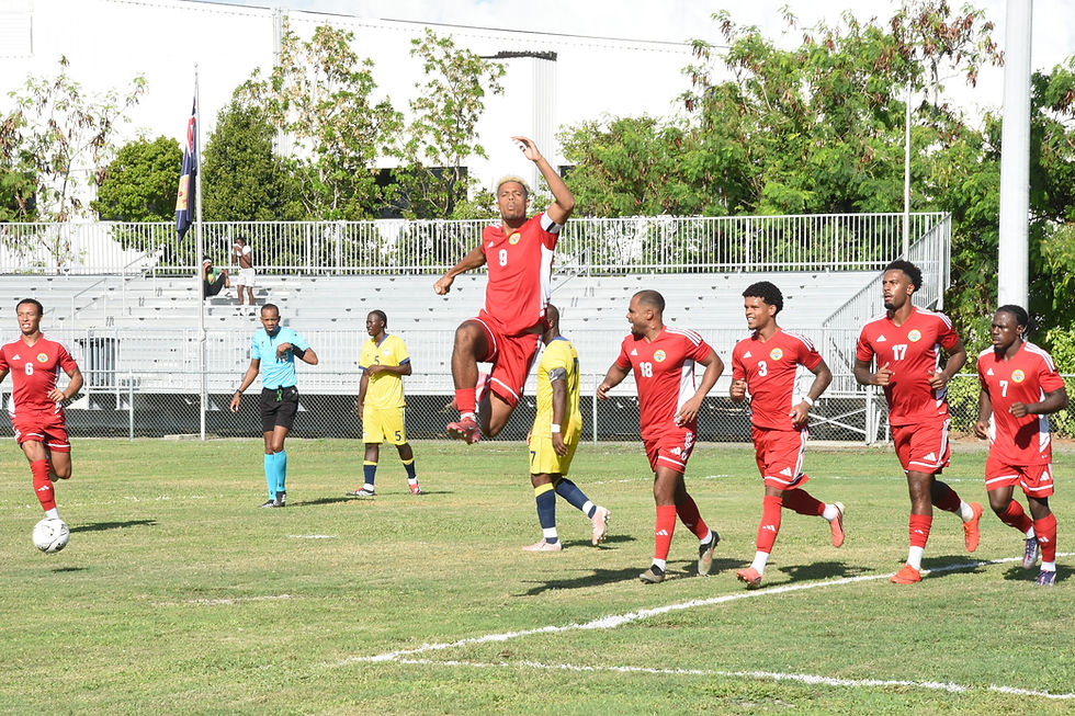 Lyle Taylor (airborne) of Montserrat celebrates one of his two penalties against the TCI in their final Concacaf Nations League game at the TCIFA Field