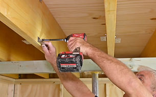 Image of Step 4 - showing how to attach the mounting brackets to joists using a power driver.