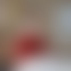 woman-in-red-sweater-leaning-on-white-table