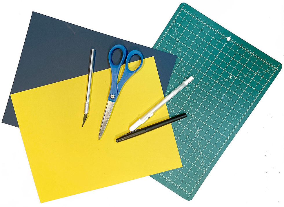 Construction paper, xacto knife, pens, scissors, cutting mat