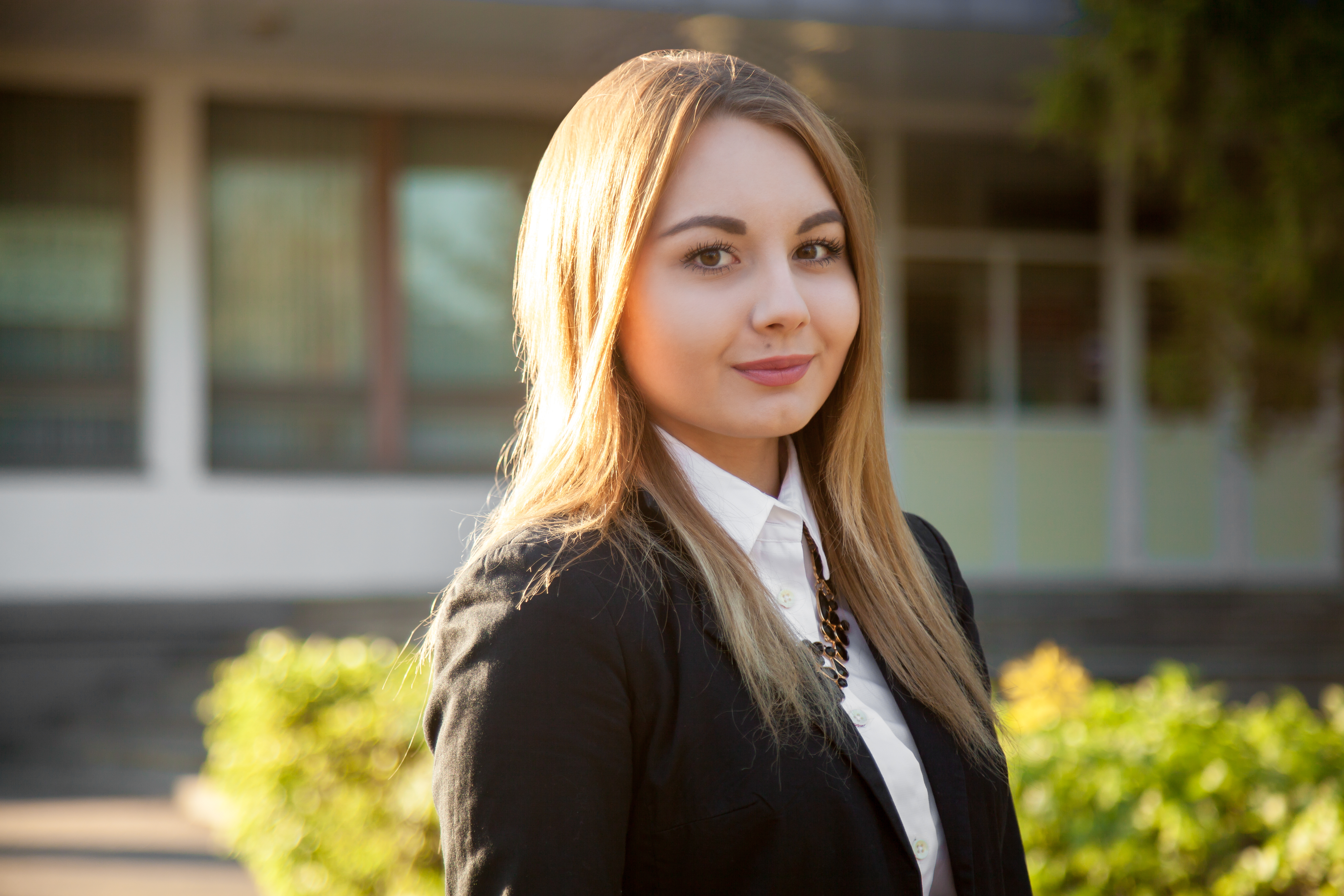 Junges Model im schwarzen Blazer vor Gebäude