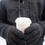 Thumbnail: Man wearing Gray Men's 3M Thinsulate Thermal Fleece Gloves and holding a cup of coffee