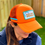 Thumbnail: Side view of a woman wearing an Orange Play More Pickle Hat