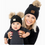 Thumbnail: Mom and baby wearing matching Adult/Baby Faux Fur Pom Knit Beanie Hats in Black