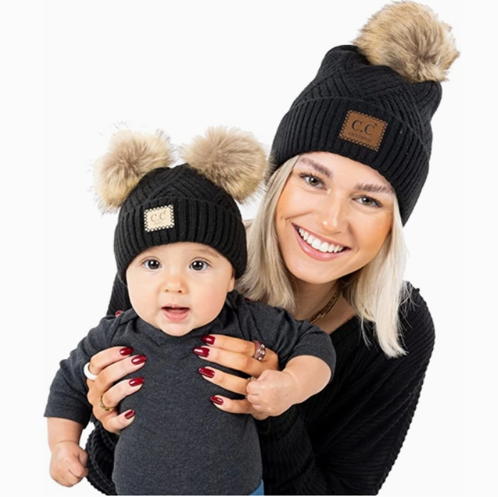 Mom and baby wearing matching Adult/Baby Faux Fur Pom Knit Beanie Hats in Black