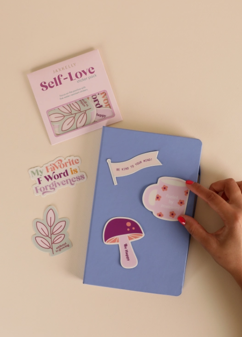 Thumbnail: Fun Vinyl Sticker Packs - Self-Love Packaging shown on a journal
