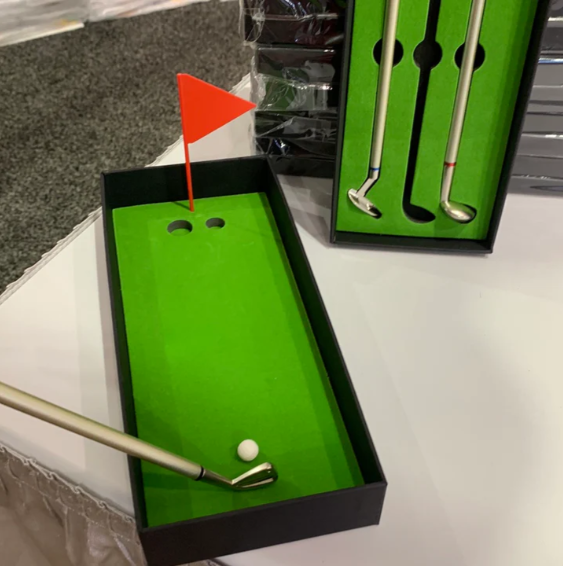 Golf Pen Set on a table showing how to set up your golf ball for the putt