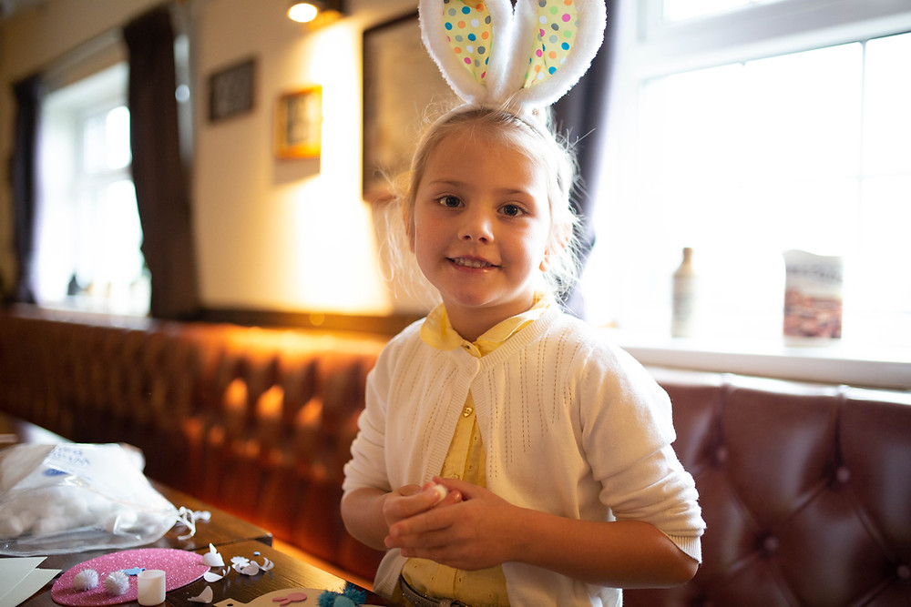 A girl at The Blue Stoops Breakfast with the Easter Bunny event.