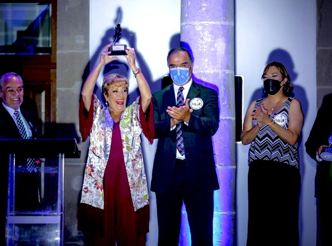 Woman accepting award, celebrating with others