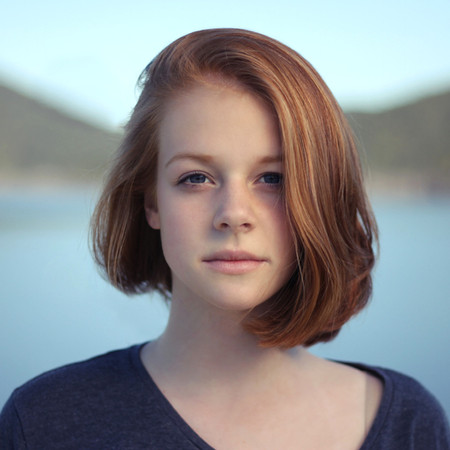 A woman with red hair that just had her hair straightened.
