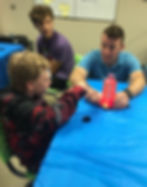 Lava lamp fun in action—Robert talks with student Luke with his lava lamp while Eli looks on!