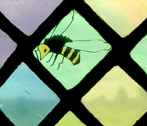 Queen honeybee in the transom. Detail from Window 8: The Woman at the Well at the church of Saints Leonard and Fergus, Dundee, Scotland. Designed and made by AJ Naylor.