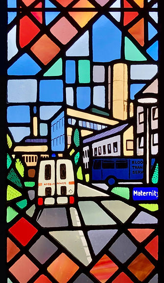 Ninewells Hospital, Dundee, an emblem of compassion and care. In Window 21: The Good Samaritan in the church of Saints Leonard and Fergus, Dundee, Scotland. Designed and made by AJ Naylor.