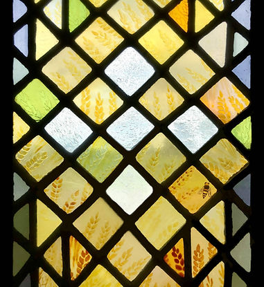 The communion host, depicted in an abstract way with five white seedy quarries. Detail from Window 14: The Eucharistic Bread in the church of Saints Leonard and Fergus, Dundee, Scotland. Designed and made by AJ Naylor.