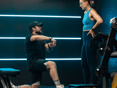A man explaining a new exercise to one of his clients