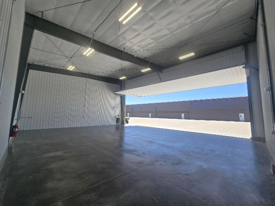 Empty hangar interior with open hydraulic door.