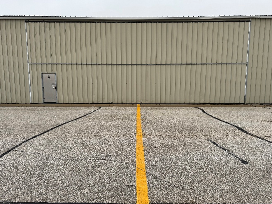 Exterior view of a t-hangar with the bi-fold door shut.
