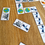 Thumbnail: Close-up of space-themed domino game in action, featuring tiles with planets, satellites, and astronauts.