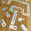 Thumbnail: Printed and cut space-themed domino tiles laid out on a wooden table, ready for play.