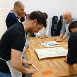 a group of men making fresh Italian Pasta