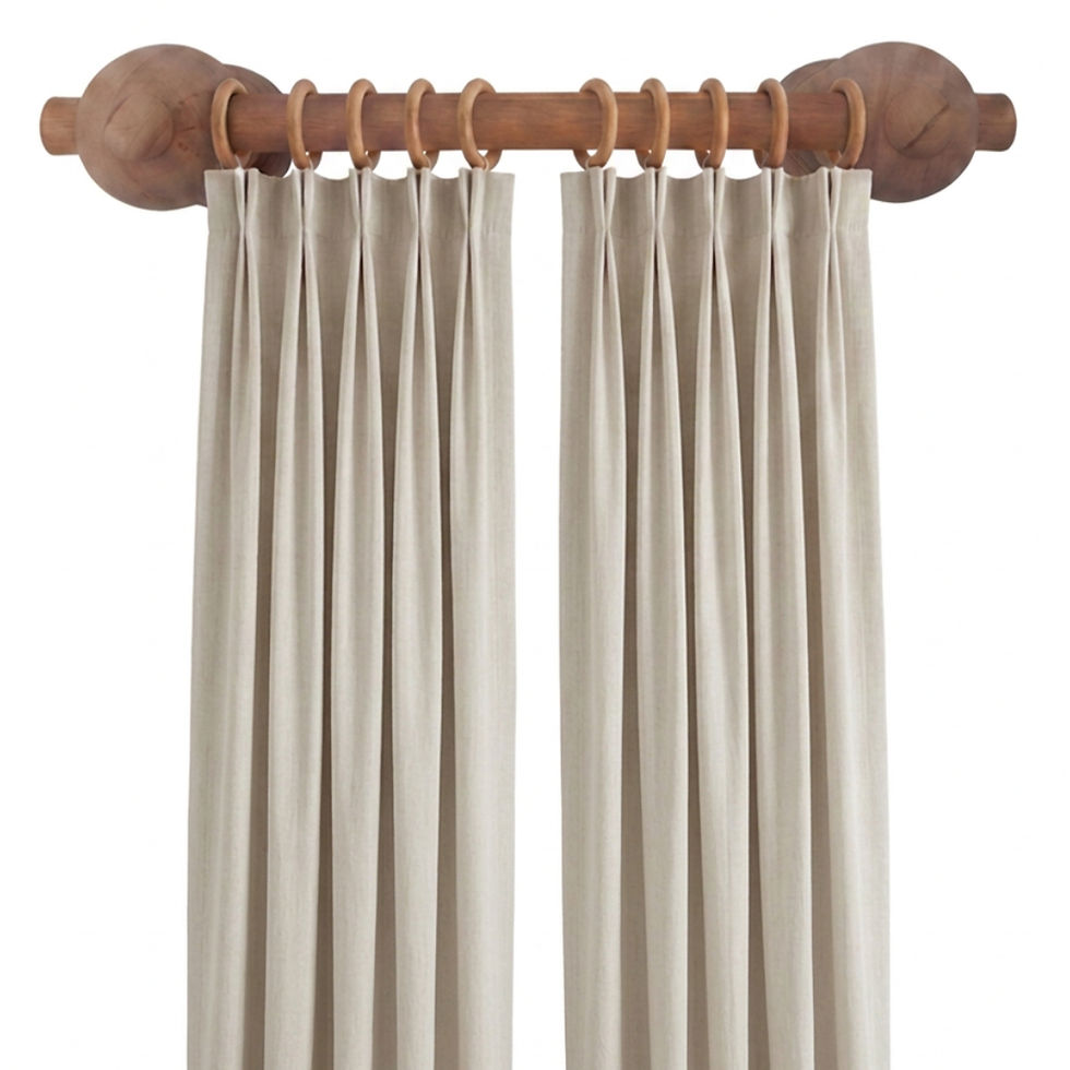 Close-up view of wooden curtain rail with curtain rings