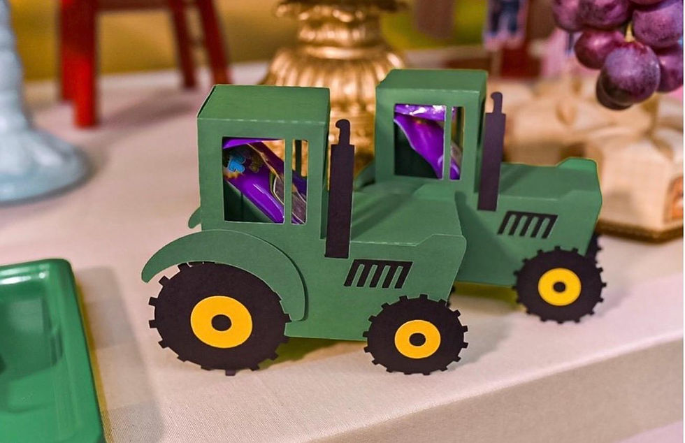 Handmade green tractor treat boxes at a farm party.