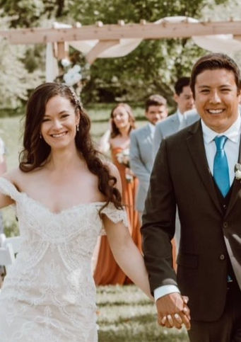 happy wedding clients walking down the aisle