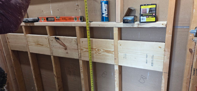 Bathroom remodeling in progress in Millcreek, Erie County, PA showing shower reframing, niche framing, and blocking for future support rails by CBC Remodeling & Services