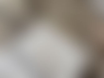 a blank journal on a woven blanket surrounded by crystals