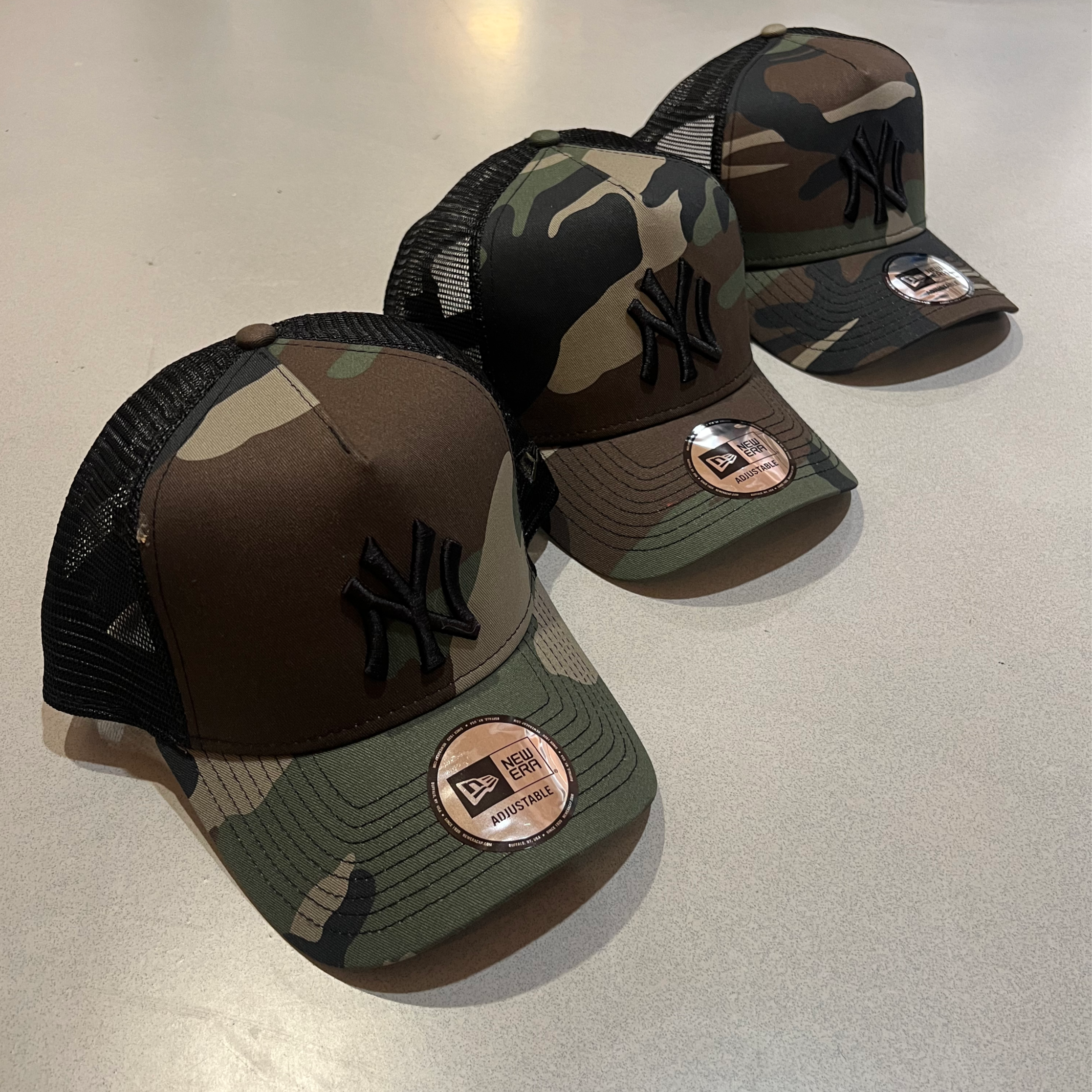 New Era Woodland Camo Trucker Caps
