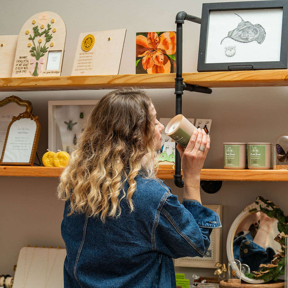 Enoy the aroma of a scented candle in their cozy shop filled with art pieces and thoughtful gifts designed to evoke a sensory experience.