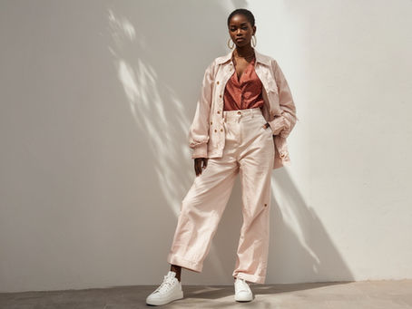 Model posing in a lightweight jacket and pants combo